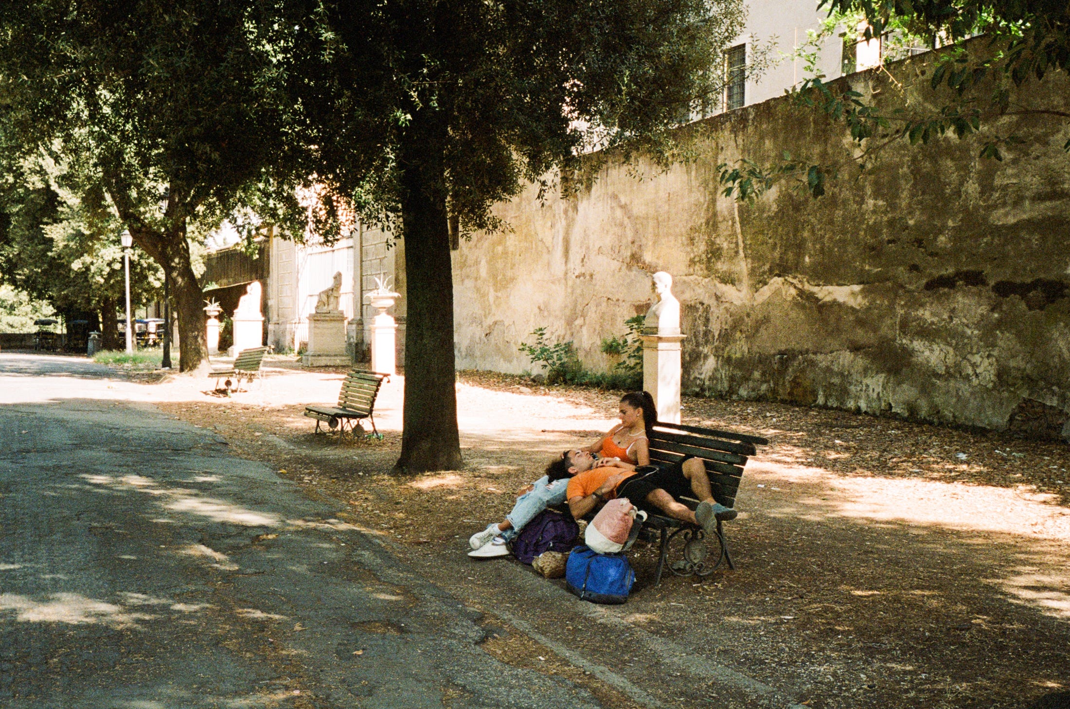 A couple, together in the park after a long day. Rome 2022
