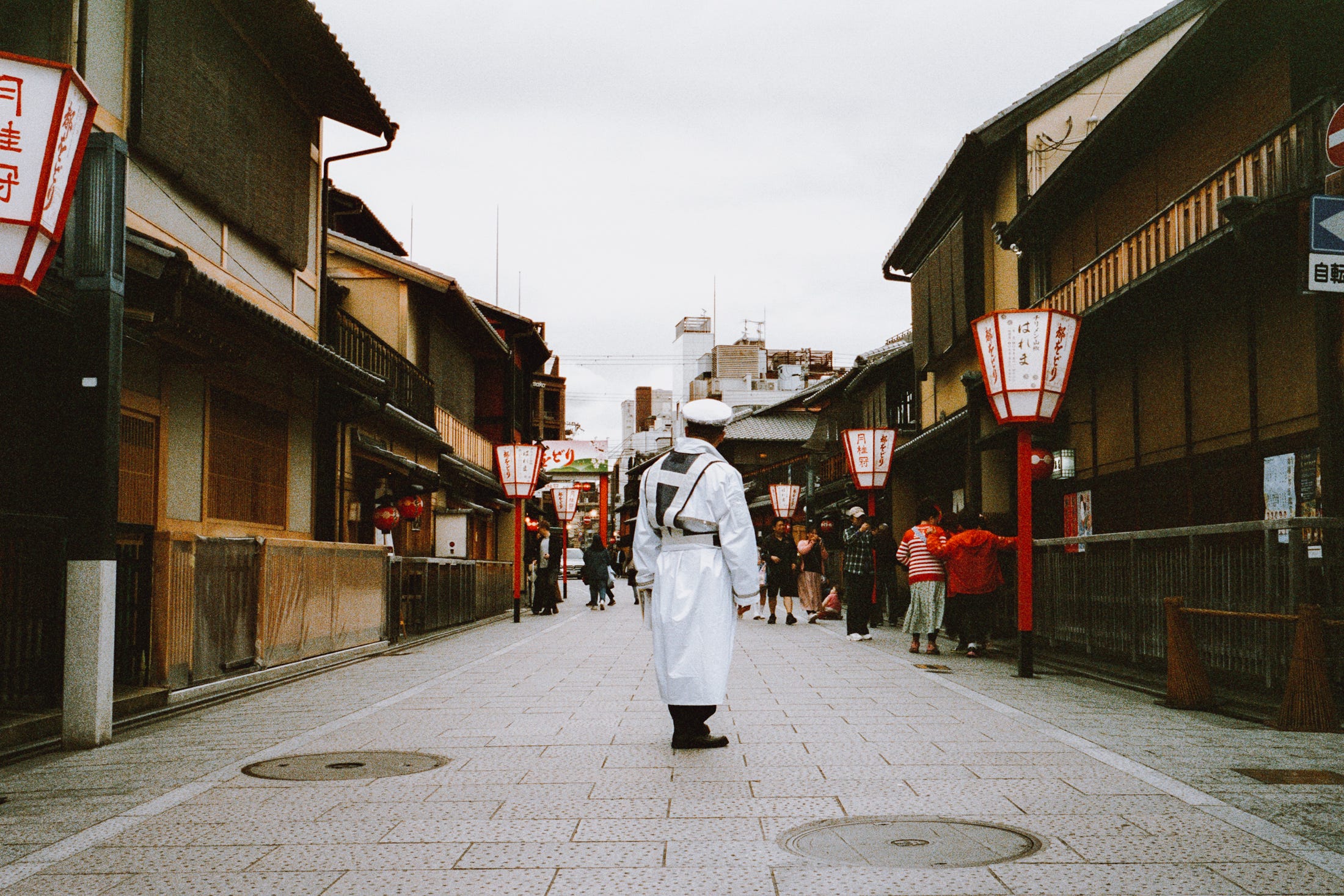 A man stands in Gion, waiting to yell at tourists. Dream job. Kyoto, 2024